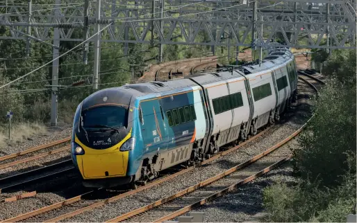  ??  ?? Avanti West Coast Class 390 Pendolino 390152 sweeps round the reverse curves at Baddesley Bridge, Atherstone on September 25, 2020 while forming the 1H67 1240 Euston to Manchester Piccadilly. The operator will be under a management contract from March 2022. (Graham Nuttall)