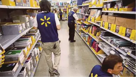  ?? BLOOMBERG PIC ?? Walmart US reported a net income of US$2.9 billion in the second quarter, down 23.2 per cent from a year ago.