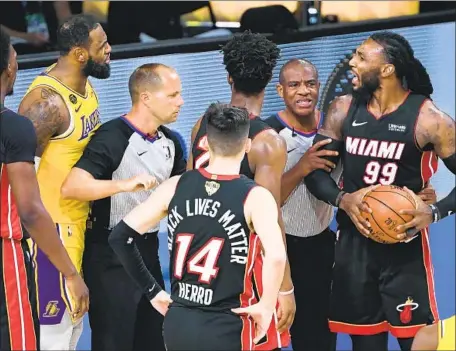  ?? REFEREES Photog r aphs by Wally Skalij Los Angeles Times ?? separate LeBron James, left, and Jae Crowder. The Lakers broke a tie in the fourth quarter to take a 3- 1 series lead.