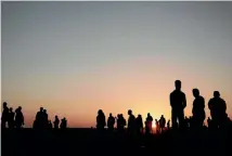  ?? PHOTO: AP ?? The sun sets over Palestinia­n protesters gathered at the Gaza Strip border with Israel, in eastern Gaza City, yesterday.