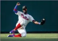  ?? LAURENCE KESTERSON — THE ASSOCIATED PRESS ?? Phillies outfielder Andrew McCutchen (22) fields a single by Colorado’s Trevor Story during the fifth inning.