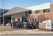  ?? [PHOTO PROVIDED] ?? John Marshall Mid-High students gather in front of the school Wednesday morning to draw attention to gun violence.