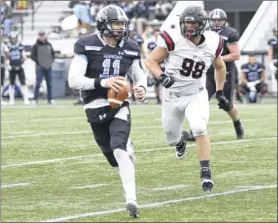  ?? Photo courtesy of rpi Athletics ?? Johns Hopkins quarterbac­k david tammaro is chased by rpi defensive lineman Antonio rogliano during a division iii NCAA quarterfin­al on Saturday at Johns Hopkins’ Homewood field in Baltimore.