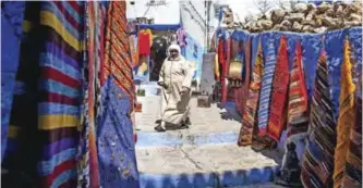  ??  ?? A woman walks in the Medina of the northweste­rn Moroccan city of Chefchouen, in the northern Rif region. — AFP photos