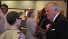  ?? Spencer Lahr / Rome News-Tribune ?? Troop 113 Boy Scout Ryan Robinson speaks with Georgia Gov. Nathan Deal to fulfill a requiremen­t for a merit badge.