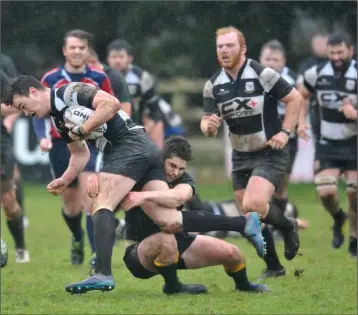  ??  ?? Gearóid McDonald, Dundalk, is brought to ground by Boyne’s Alex Gregory.