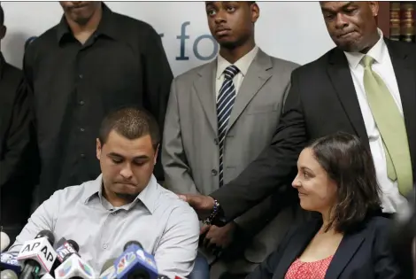  ?? RICHARD DREW — THE ASSOCIATED PRESS FILE ?? Plaintiff in the stop and frisk case David Ourlicht, seated left, is comforted by Merault Almonar, standing at right, father of plaintiff Devin Almonar, standing center, during a news conference at the Center for Constituti­onal Rights, in New York, after U.S. District Judge Shira Scheindlin ruled that the New York Police Department deliberate­ly violated the civil rights of tens of thousands of New Yorkers with its contentiou­s stop-and-frisk policy. Standing at left is plaintiff Leroy Downes while attorney Jenn Borchetta listens, seated right.