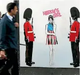  ?? PHOTO: REUTERS ?? People walk past a piece of street art by Pegasus in London depicting Meghan Markle.