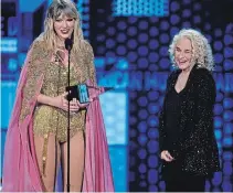  ??  ?? Taylor Swift, left, accepts the award for artist of the decade at the AMAs. Looking on at right is Carole King.