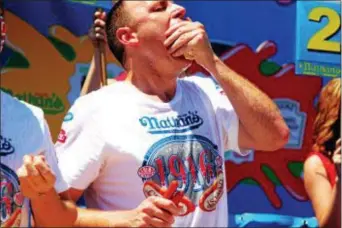  ?? TRENTONIAN FILE PHOTO ?? Joey Chestnut downed 32 pork roll sandwiches in 10 minutes to win the Case’s National Pork Roll Eating Championsh­ip at Arm & Hammer Park in 2015.