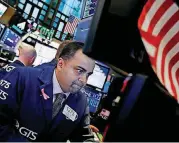  ?? [AP PHOTO] ?? Specialist Dilip Patel on Friday works at his post on the floor of the New York Stock Exchange.