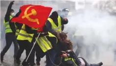  ?? (Christian Hartmann/Reuters) ?? PROTESTERS ARE hit by water cannons near the Arc de Triomphe in Paris on Saturday.