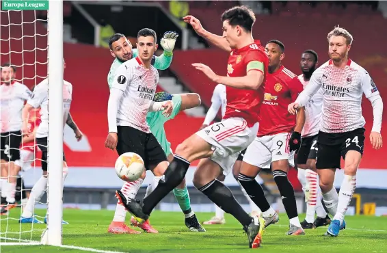  ?? LAURENCE GRIFFITHS/GETTY IMAGES ?? Big miss:
Manchester United captain Harry Maguire somehow manages to hit the post rather than tap the ball into the net