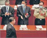  ?? REUTERS ?? Chinese President Xi Jinping (bottom, left) is welcomed by ministers n as he arrives for the opening session of the National People's Congress at the Great Hall of the People in Beijing on Friday.