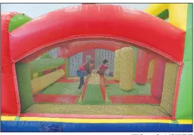  ?? NWA Democrat-Gazette/J.T. WAMPLER ?? Children race through an inflatable obstacle course Monday at The Jones Center in Springdale.