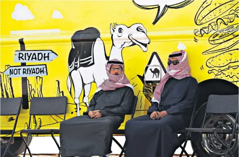  ??  ?? Men at a camel beauty contest, part of Saudi Arabia’s annual Camel Festival, 100 miles east of Riyadh, as the country prepares for a tourism drive