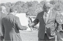  ?? MARK HUMPHREY AP ?? UAW President Ray Curry (right) bumps fists with Jim Farley, Ford president and CEO after a presentati­on on the planned factory near Memphis, Tenn.