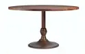  ?? ARHAUS ?? An Amish-made Wade round dining table by Arhaus. The piece has a sleek walnut top perched on a simple yet elegant cast iron base; a nice marriage of midcentury and French bistro style.