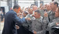  ??  ?? 2009: President Barack Obama is greeted by soldiers during a visit to Baghdad.