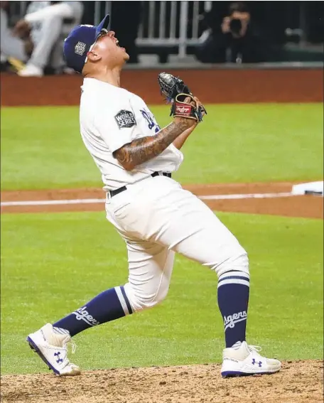  ?? Photog r aphs by Robert Gauthier Los Angeles Times ?? JULIO URÍAS lets loose after recording the f inal seven outs. The Dodgers’ bullpen threw 71⁄ shutout innings in the clincher. 3