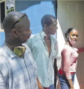  ??  ?? Lesa Angus opens the door to her family’s new home as councillor for the Red Hills Division in West Central St Catherine Keith Mccook (left) and Lesa’s father Barrington look on.