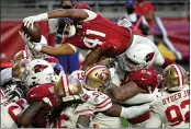  ?? RICK SCUTERI — THE ASSOCIATED PRESS ?? Cardinals running back Kenyan Drake (41) dives over the line for a touchdown against the 49ers during the second half on Saturday in Glendale, Ariz.