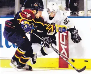  ?? TAMI CHAPPELL/REUTERS ?? Thrashers defenceman Niclas Havelid tries to slow down Pittsburgh Penguins rookie centre Sidney Crosby along the boards in action last night. Crosby and the rest of his teammates failed to get a point.