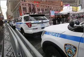  ?? KATHY WILLENS — THE ASSOCIATED PRESS FILE ?? A line of police cars are parked along a street in Times Square, Thursday, Dec. 29, 2016, in New York. A New York City police officer is speaking out against the use of “courtesy cards” by friends and relatives of his colleagues on the force, accusing department leaders of maintainin­g a sprawling system of impunity that lets people with a connection to law enforcemen­t avoid traffic tickets.