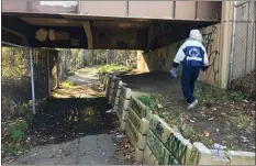  ??  ?? A youth makes his way along the walkway on MacDade Boulevard in Ridley Township.