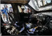  ?? ABDEL KAREEM HANA — THE ASSOCIATED PRESS ?? People inspect the site where World Central Kitchen workers were killed in Deir al-Balah, Gaza Strip, on Tuesday.