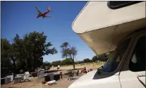  ?? DAI SUGANO — STAFF ARCHIVES ?? An airplane flies over the homeless encampment located along Coleman Avenue in San Jose in 2021.