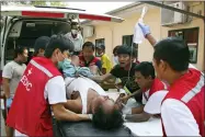  ?? AP PHOTO, FILE ?? FILE - An injured anti-coup protester is brought for medical treatment to a hospital in Latha township, Yangon, Myanmar, Saturday, March 27, 2021. The prospects for peace in Myanmar, much less a return to democracy, seem dimmer than ever two years after the army seized power from the elected government of Aung San Suu Kyi, experts say.