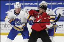  ?? JEFFREY T. BARNES — THE ASSOCIATED PRESS ?? Buffalo Sabres defenseman Rasmus Dahlin (26) and New Jersey Devils forward Andteas Johnsson (11) compete for position during action from last week.