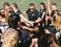  ?? STAFF FILE ?? Kellam girls soccer coach Mario Hurdle, center, and his Knights have relied on many goal-scorers and excellent defense to stay undefeated this season.