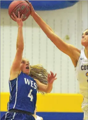  ?? PETE BANNAN — DIGITAL FIRST MEDIA ?? Downingtow­n East center Bella Smuda, who is 6 feet, 5 inches tall, blocks a shot from 5-foot-2 Sammie Sipes in the first quarter Monday.