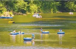  ?? JERRY JACKSON/BALTIMORE SUN ?? Tubers try to beat the July heat on the Big Gunpowder Falls in Monkton on Thursday.