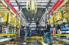  ?? YANG LEI / XINHUA ?? Workers man an assembly line at a BYD car manufactur­ing facility in Lancaster, California, in March. The Chinese automaker aims to take a 30 percent share of the electric bus market in North America.