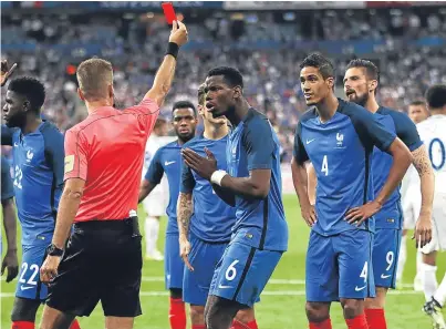  ?? Picture: Getty Images. ?? Paul Pogba questions referee Davide Massa as he shows Raphael Varane a red card after the video assistant referees confirmed the penalty decision.