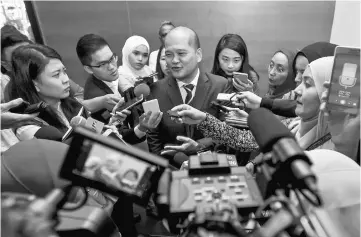  ??  ?? Shahril (centre) speaking to media after launch of financial education and retirement module ‘The Start of New Journey’. — Bernama photo