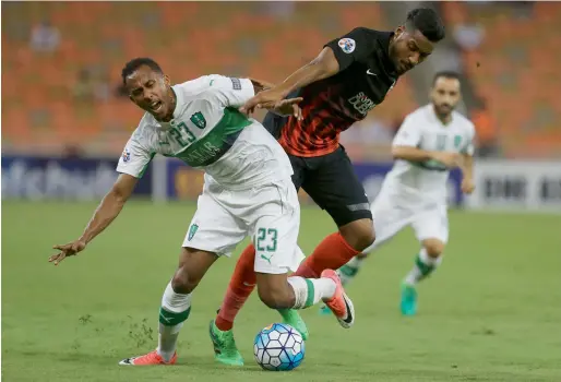  ?? AFP ?? Saudi Al Ahli’s Saeed Al Muwallad (left) vies for the ball against UAE Al Ahli’s Khamis Ismail during their AFC Champions League match in Jeddah. —
