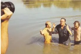  ??  ?? Cash is baptized in the River Jordan in Israel in 1971 during a film shoot.