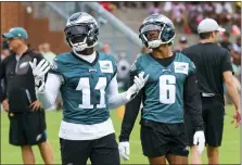  ?? CHRIS SZAGOLA — THE ASSOCIATED PRESS ?? Philadelph­ia Eagles’ A.J. Brown, left, reacts with DeVonta Smith, right, during practice at NFL football team’s training camp Wednesday in Philadelph­ia.