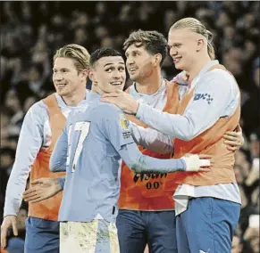  ?? FOTO: GYI ?? Haaland y De Bruyne, suplentes Ambos y Stones felicitan a Foden tras su tercer gol