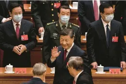  ?? KEVIN FRAYER/GETTY ?? Chinese President Xi Jinping waves to senior officials on Sunday as he leaves at the end of the opening ceremony of the Communist Party congress in Beijing.