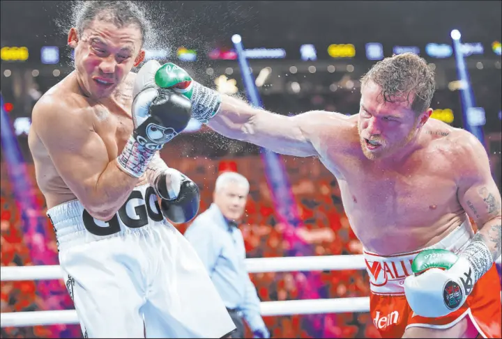  ?? Erik Verduzco Las Vegas Review-journal ?? Saul “Canelo” Alvarez delivers a crushing right to Gennady Golovkin in the fifth round of their undisputed super middleweig­ht title fight Saturday night at T-mobile Arena.