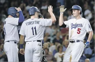  ?? Jae C. Hong Associated Press ?? ON JUNE 20, Corey Seager, right, hit three home runs in a game for the second time in his career. He led a five-homer attack in the Dodgers’ 12-0 victory over the New York Mets.