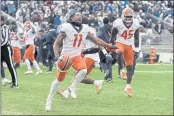  ?? BARRY REEGER — THE ASSOCIATED PRESS ?? Illinois wide receiver Carlos Sandy (11) and linebacker Khalan Tolson (45) celebrate their 20-18victory over Penn State in the ninth overtime on Saturday.