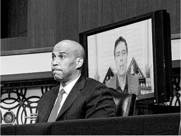  ?? KEN CEDENO/GETTY ?? Sen. Cory Booker, D-N.J., left, questions former FBI Director James Comey on Wednesday in Washington.