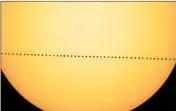  ?? NASA’S GODDARD SPACE FLIGHT CENTER ?? In a composite image provided by NASA, the planet Mercury will cut a diagonal path left to right across the sun.