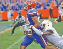  ?? THE ASSOCIATED PRESS ?? Tennessee defensive back Justin Martin knocks the ball loose from Florida running back Malik Davis (20) on the 2-yard line after Davis had run 72 yards during the second half Saturday.